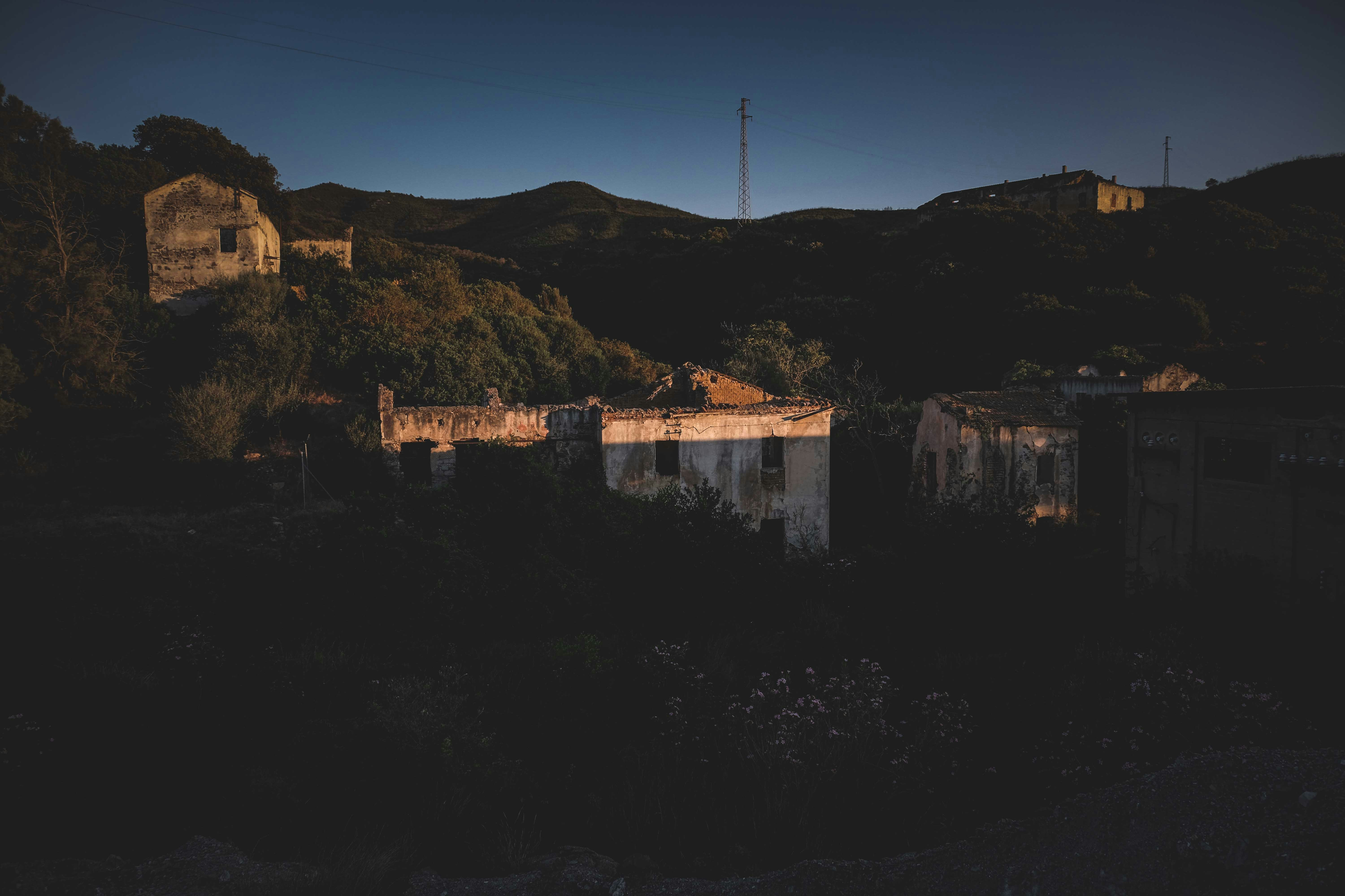 brown concrete building on hill during daytime